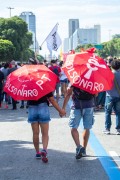 Activists couple with protest words under umbrella - Demonstration in opposition to the government of President Jair Messias Bolsonaro - Rio de Janeiro city - Rio de Janeiro state (RJ) - Brazil