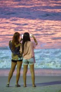 Women photographing with cell phone the sunrise on Copacabana Beach - Rio de Janeiro city - Rio de Janeiro state (RJ) - Brazil