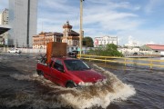 Car passing through flooded street in the historic center of Manaus during the biggest flood of the Rio Negro since the beginning of records in 1902 - Manaus city - Amazonas state (AM) - Brazil