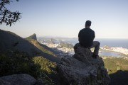 Man watching the city from trail of Queimado Mountain with the Christ the Redeemer and the Sugar Loaf in the background  - Rio de Janeiro city - Rio de Janeiro state (RJ) - Brazil