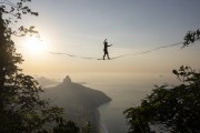 Practitioner of slackline on the top of Rock of Gavea - Sao Conrado and Two Brothers Mountain in the background  - Rio de Janeiro city - Rio de Janeiro state (RJ) - Brazil