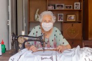 Senior seamstress wearing Covid-19 protective mask while working - Guarani city - Minas Gerais state (MG) - Brazil