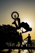 Cyclist doing bicycle maneuvers on the largest skate park in Latin America on the banks of the Guaiba River at sunset - Porto Alegre city - Rio Grande do Sul state (RS) - Brazil