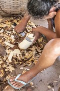 Woman sitting on the floor peeling raw cassava with knife - Santo Amaro do Maranhao city - Maranhao state (MA) - Brazil