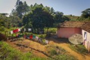 Outside side of small rural house with clothes hanging on clothesline - Guarani city - Minas Gerais state (MG) - Brazil