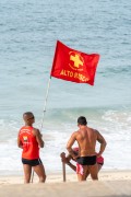 Firefighter lifeguard planting a high risk red flag for swimming in the sands of Ipanema Beach - Rio de Janeiro city - Rio de Janeiro state (RJ) - Brazil