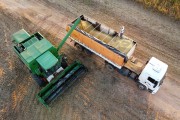 Picture taken with drone of harvester unloading Soybean in Bulk Truck - Planalto city - Sao Paulo state (SP) - Brazil
