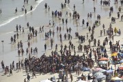 Bathers cluster around bather saved from drowning by Military Police helicopter at Pitangueiras Beach - Guaruja city - Sao Paulo state (SP) - Brazil