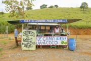 Woman selling sugarcane juice and pastel at a stall on the side of the MG-33 highway - between Guarani and Rio Novo - Guarani city - Minas Gerais state (MG) - Brazil