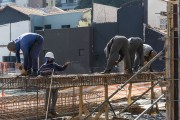 Construction workers assembling iron armor used on pillars and wearing masks due to the coronavirus pandemic - Sao Paulo city - Sao Paulo state (SP) - Brazil
