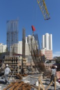 Construction workers guiding the lifting of iron armor used in pillars - Sao Paulo city - Sao Paulo state (SP) - Brazil