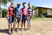 Indigenous children of the Truka ethnicity playing Caretas or caboclos - teenagers who take to the streets masked in Holy Week asking for donations in money or food in the Caatinga Grande community - Cabrobo city - Pernambuco state (PE) - Brazil