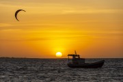 Practitioner of kitesurf and fishing boat at sunset - Cajueiro da Praia city - Piaui state (PI) - Brazil