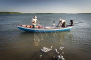 Fishermen in a boat collecting fishing nets in the Parnaiba Delta - Araioses city - Maranhao state (MA) - Brazil