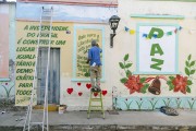 Man making painting in favor of peace, freedom and democracy on a house wall - Sao Joao del Rei city - Minas Gerais state (MG) - Brazil