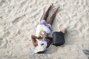 Man sleeping on the sand of Ipanema Beach after New Years Eve 2023 - Rio de Janeiro city - Rio de Janeiro state (RJ) - Brazil