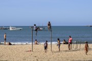 Teenagers playing on a gym bar and bathers at Volta da Jurema Beach - Fortaleza city - Ceara state (CE) - Brazil