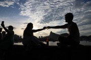 People socializing and drinking sitting by the sea in Short wall of Urca  - Rio de Janeiro city - Rio de Janeiro state (RJ) - Brazil