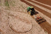 Picture taken with drone of tractor subsoiling the earth with limestone - Poloni city - Sao Paulo state (SP) - Brazil