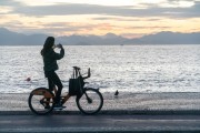 Woman photographing with cell phone the sunrise on Copacabana Beach - Rio de Janeiro city - Rio de Janeiro state (RJ) - Brazil