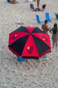 Sun umbrella made with colors and symbol of Flamengo - Arpoador Beach - Rio de Janeiro city - Rio de Janeiro state (RJ) - Brazil