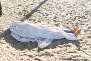Man sleeping on the beach sand - Copacabana Beach - Rio de Janeiro city - Rio de Janeiro state (RJ) - Brazil