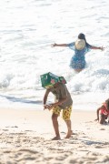 Boy playing on Copacabana Beach with cardboard box covering his head - Rio de Janeiro city - Rio de Janeiro state (RJ) - Brazil