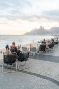 People sitting at tables at the Alalao kiosk on the Ipanema boardwalk to watch the sunset - Rio de Janeiro city - Rio de Janeiro state (RJ) - Brazil
