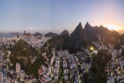 Picture taken with drone of tree-lined street and residential buildings with mountains in the background - Rio de Janeiro city - Rio de Janeiro state (RJ) - Brazil
