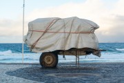 Detail of cargo trolley with material covered with canvas on the edge of Arpoador Beach - Rio de Janeiro city - Rio de Janeiro state (RJ) - Brazil