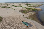 Picture taken with drone of riverine fishermen carrying a canoe on the dry bed of the Solimoes River - Careiro da Varzea city - Amazonas state (AM) - Brazil