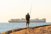 Fisherman at Arpoador Stone with cargo ship in the background - Rio de Janeiro city - Rio de Janeiro state (RJ) - Brazil