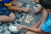 Children playing with sea shells during Festive Dawn - celebration of the centenary of the Fishing village Z-13 - on Post 6 of Copacabana Beach - Rio de Janeiro city - Rio de Janeiro state (RJ) - Brazil
