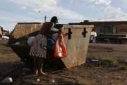 Man collecting leftover garbage in an iron dumpster - Iranduba city - Amazonas state (AM) - Brazil