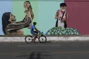 Street with wall painted with regional themes in the city of Parintins - Parintins city - Amazonas state (AM) - Brazil