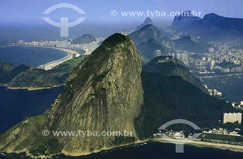  Vista aérea mostrando, do Pão de Açúcar (1).  Da direita para a esquerda: Morro da Babilônia (2); seguida da Praia de Copacabana;  e bem ao fundo à esquerda o Morro dos Dois Irmãos e a Pedra da Gávea. Em primeiro plano à direita, uma área pertencente ao Exército Brasileiro e a Enseada de Botafogo atrás ao fundo - 
Rio de Janeiro - RJ - Brasil

(1) É comum chamarmos de Pão de Açúcar, o conjunto da formação rochosa que inclui o Morro da Urca e o próprio Morro do Pão de Açúcar (o mais alto dos dois). O conjunto rochoso é Patrimônio Histórico Nacional desde 08-08-1973.

(2) É chamada de Morro da Babilônia a encosta voltada para a Praia Vermelha, no bairro da Urca, sendo que a encosta voltada para a Praia do Leme e de Copacabana - incluindo a parte mais projetada sobre o oceano à esquerda -  é chamada de Morro do Leme.  É Patrimônio Histórico Nacional desde 08-08-1973.  - Rio de Janeiro - Rio de Janeiro - Brasil