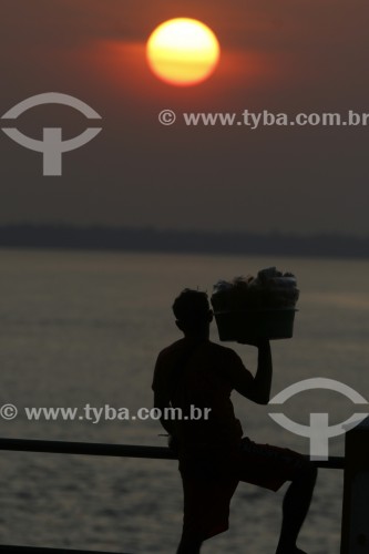 Homem olhando o por do sol na orla da cidade de Parintins - Parintins - Amazonas (AM) - Brasil