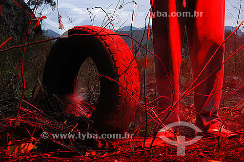  Detail of man`s leg beside a tire 