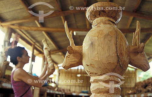  Woman observing wood craftwork - 
