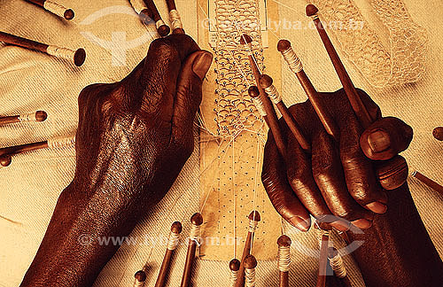  Craftwork (fabric) - detail of a black woman hands (lacemaker) working on the fabric  - Brazil