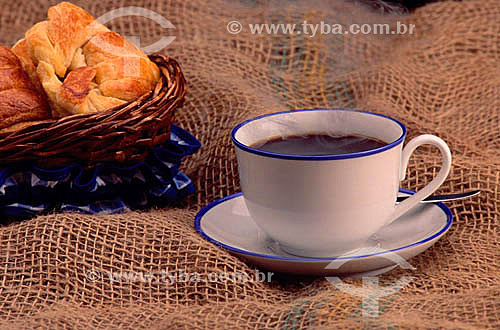  Cup of coffee and basket with breads. 