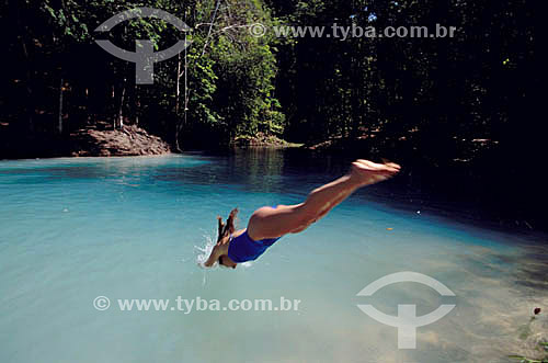  Woman jumping in the Poco Azul (Blue Well) - Maceio city - Alagoas state - Brazil 