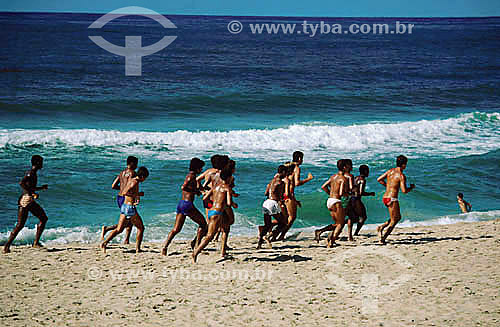  Group of men running on the sand of the beach - Salvador city - Bahia state - Brazil 