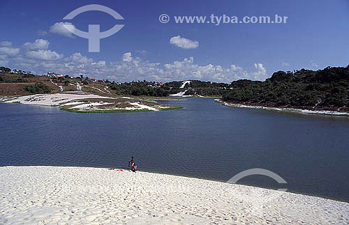  Person at a dune next to Abaete lagoon - Salvador city - Bahia state - Brazil 