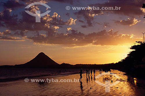  Silhouette of people walking on the Piuma Beach at sunset with the 