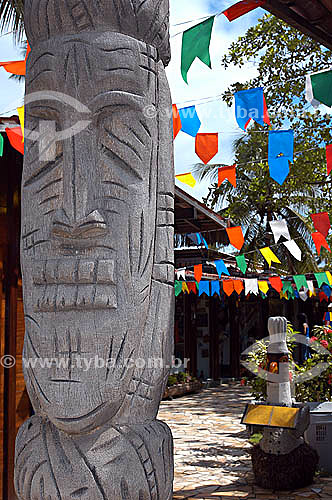  Wood statue and colorful flags - Porto de Galinhas village - Pernambuco state coast - Brazil 