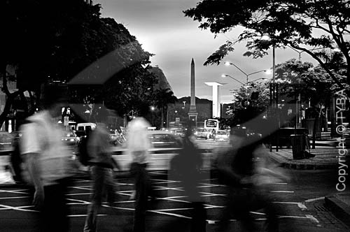  People walking in  Rio de Janeiro city downtown. In the background, at the right side, Monument to the dead of World War II, built 1957-60 - Rio de Janeiro state - Brazil 