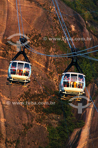  The cable car transporting tourists in the Sugar Loaf Mountain* - Rio de Janeiro city - Rio de Janeiro state - Brazil  * Commonly called Sugar Loaf Mountain, the entire rock formation also includes Urca Mountain and Sugar Loaf itself (the taller of  