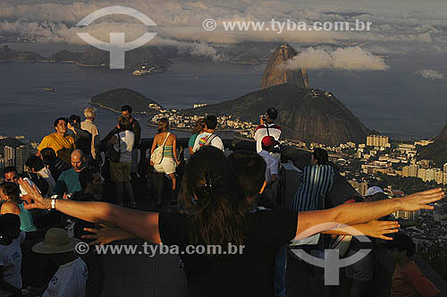  Tourists at Corcovado Mountain with the view of Sugar Loaf (*) Mountain in the background - Rio de Janeiro city - Rio de Janeiro state - Brazil  *Commonly called Sugar Loaf Mountain, the entire rock formation also includes Urca Mountain and Sugar Lo 