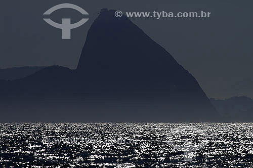  Silhouette of Sugar Loaf Mountain* sight from the sea- Rio de Janeiro city - Rio de Janeiro state - Brazil  *Commonly called Sugar Loaf Mountain, the entire rock formation also includes Urca Mountain and Sugar Loaf itself (the taller of the two). Th 